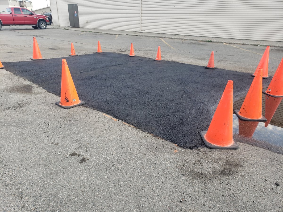 Parking lot repair work with traffic cones in place