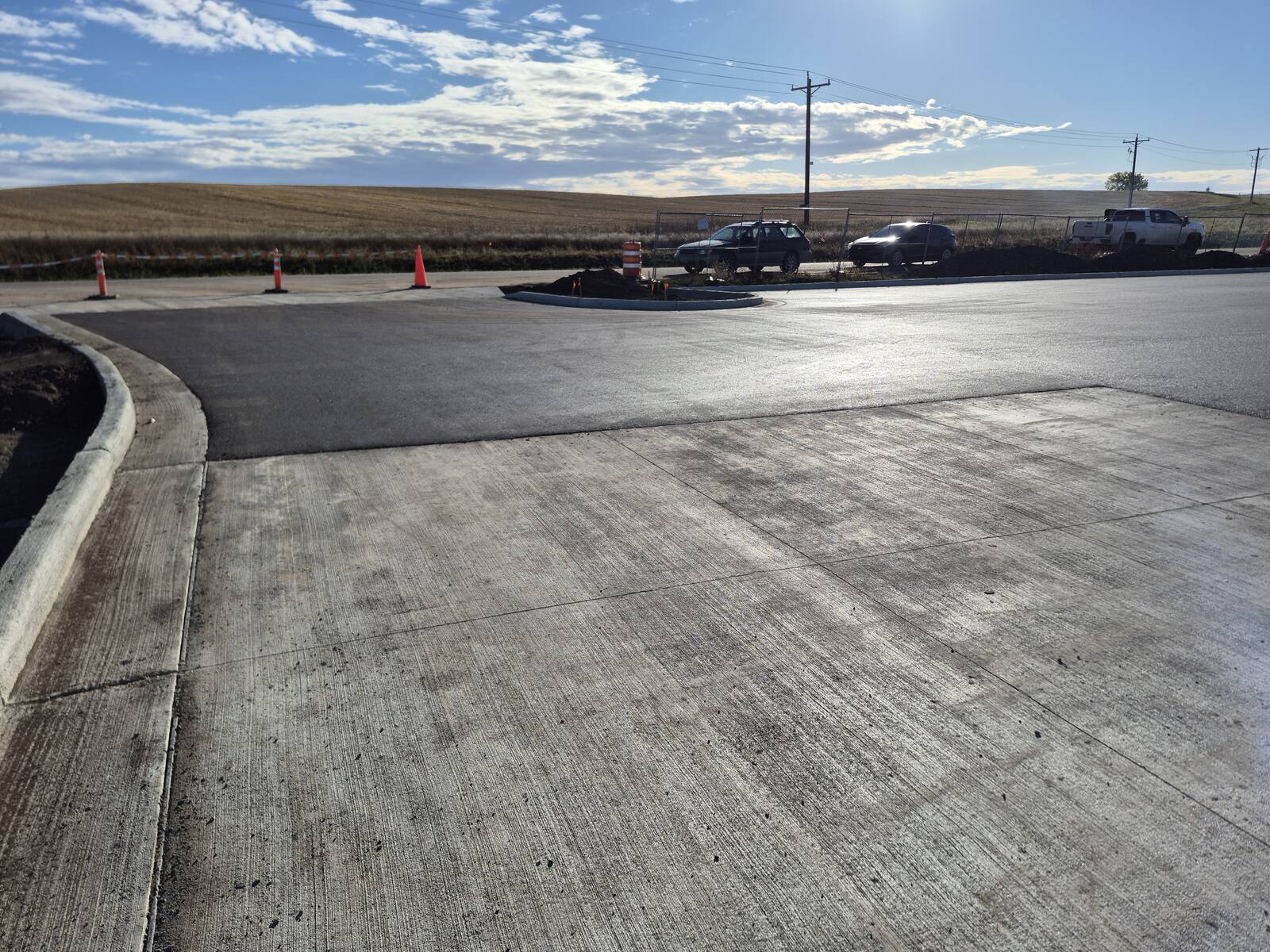 Wide view of the new curbed asphalt lot at the county park