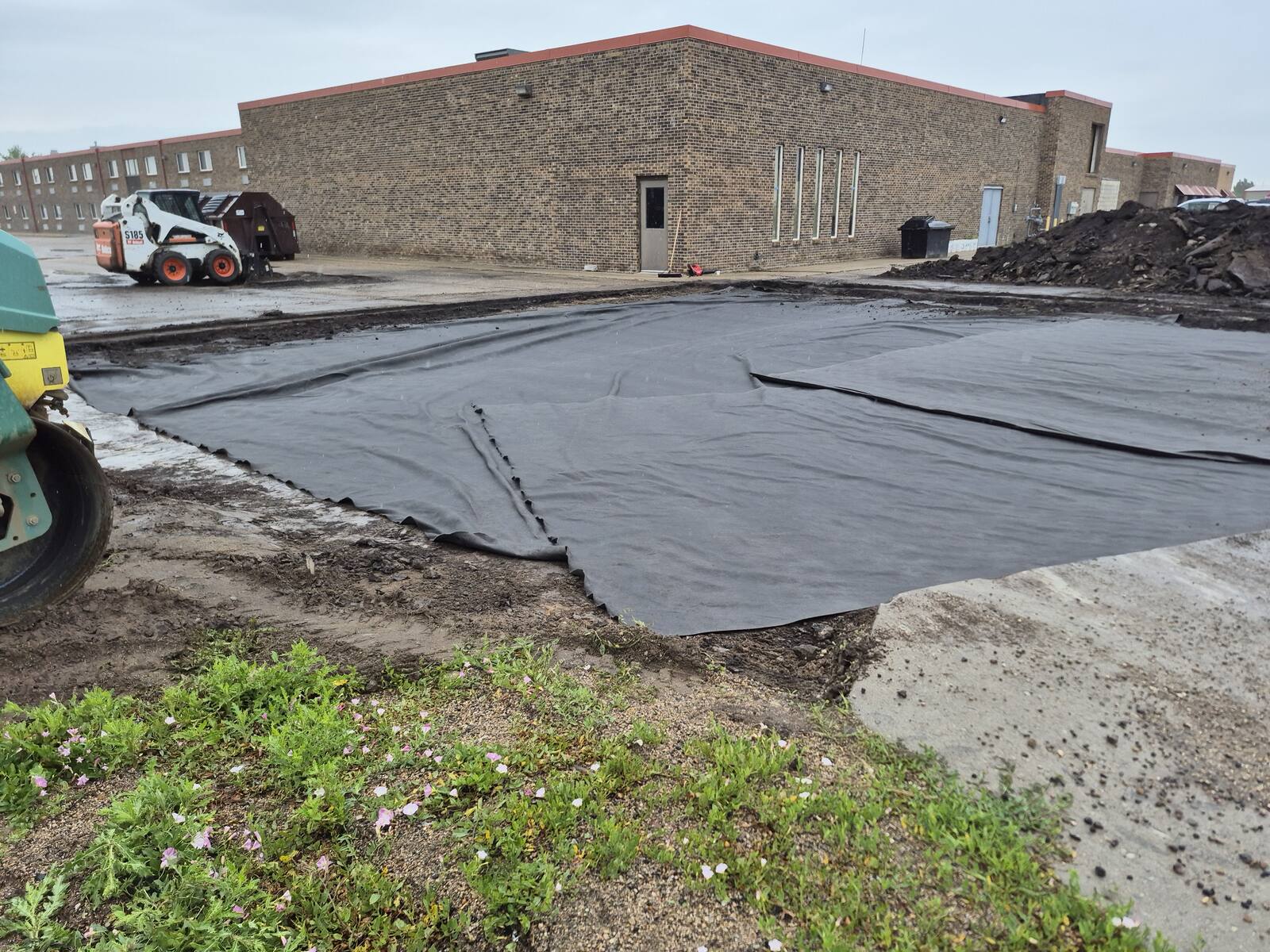Geotextile fabric laid over the subgrade before the gravel base goes down