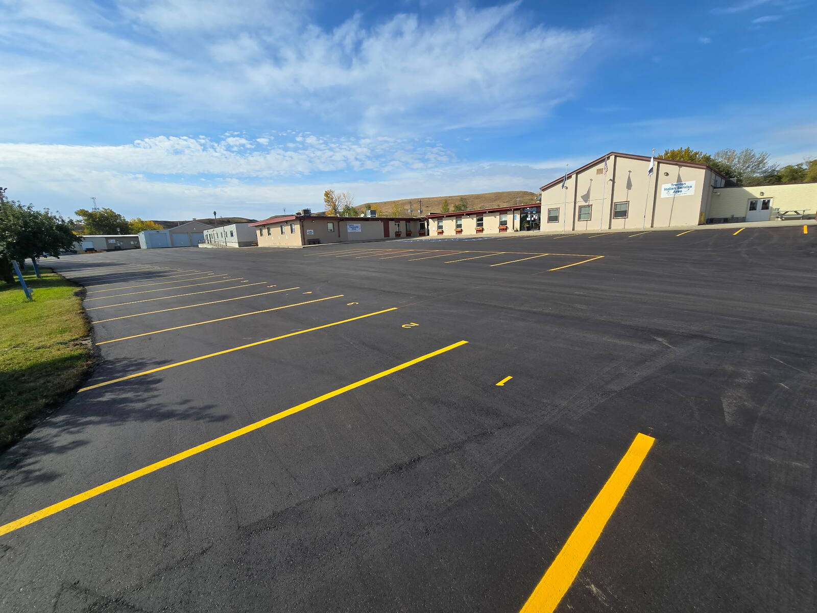 Parking lot after a 2-inch asphalt overlay with fresh yellow striping