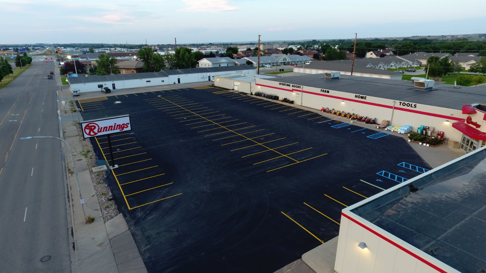 Runnings parking lot in Williston, ND after asphalt repairs, crack fill, sealcoat, and new striping